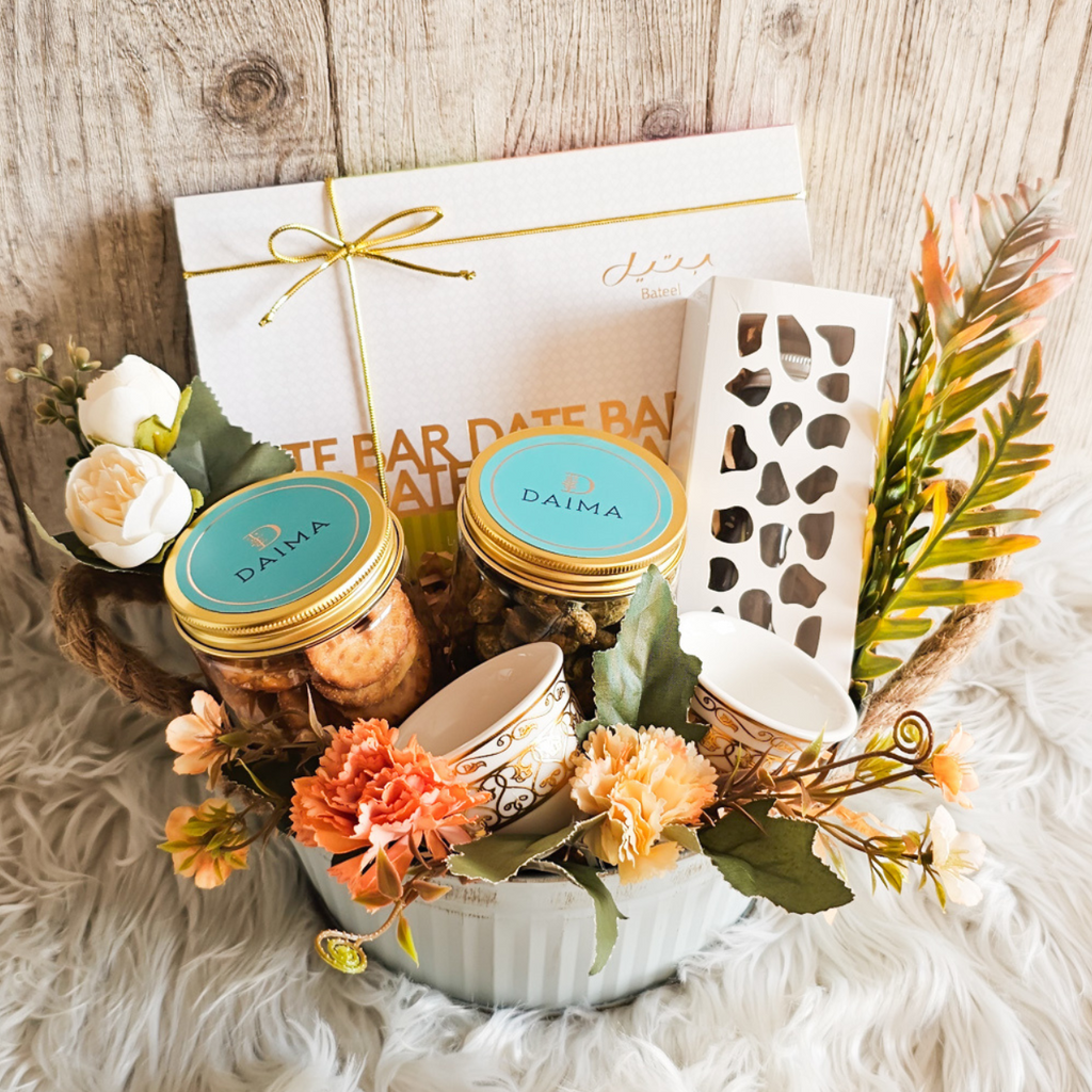 Elegant Oasis Gift Set beautifully wrapped with flowers, decorations, and an array of delicious treats—ideal for gifts this Ramadan.