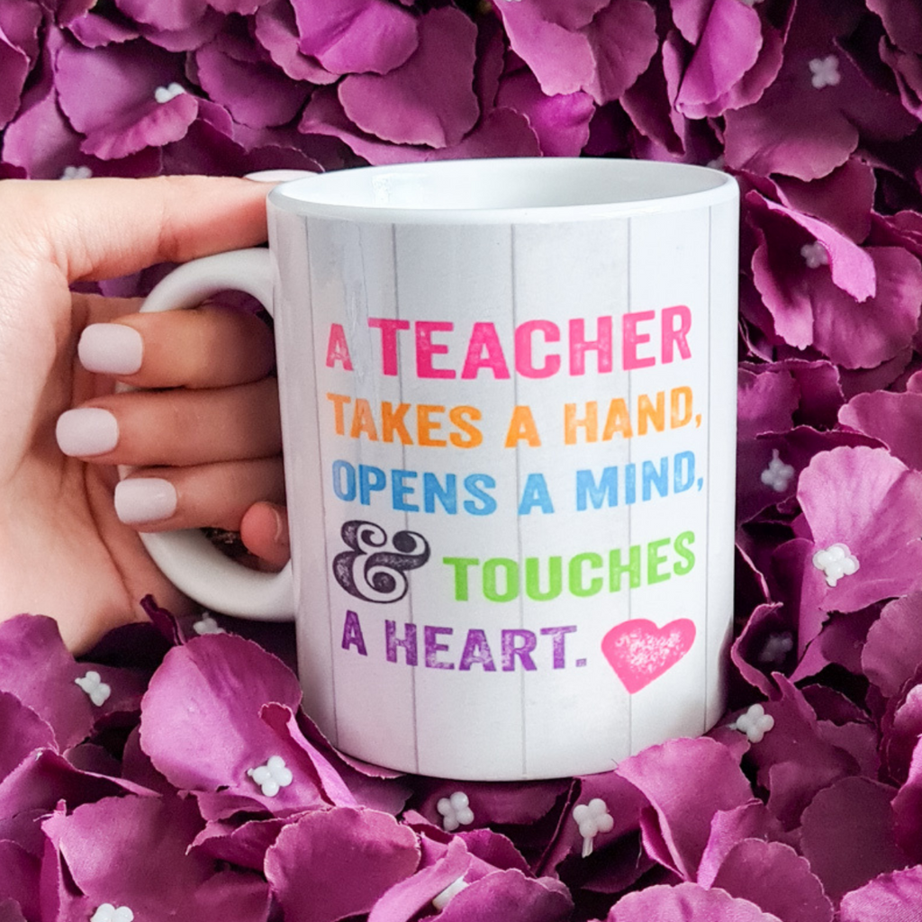 A Teacher Touches A Heart Mug